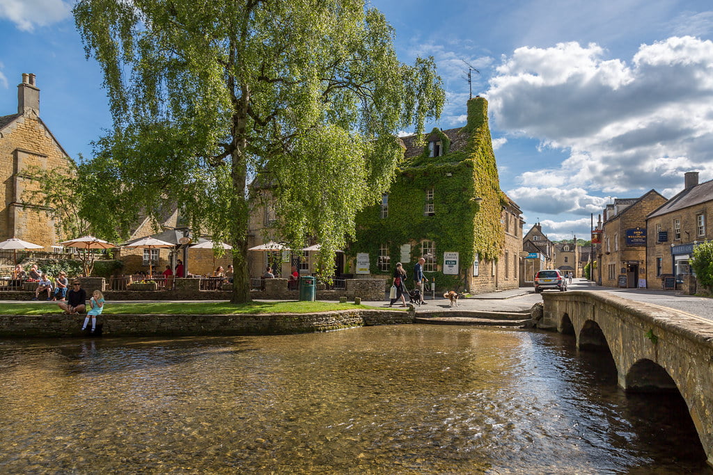 A picturesque bridge over River Windrush in Bourton-on-the-Water, blending nature and architecture harmoniously.