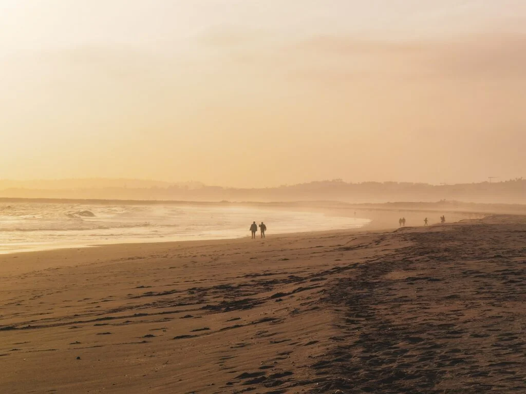 Lambeth Walk Beach, where people are walking while talking to each other. Beaches in St Ives