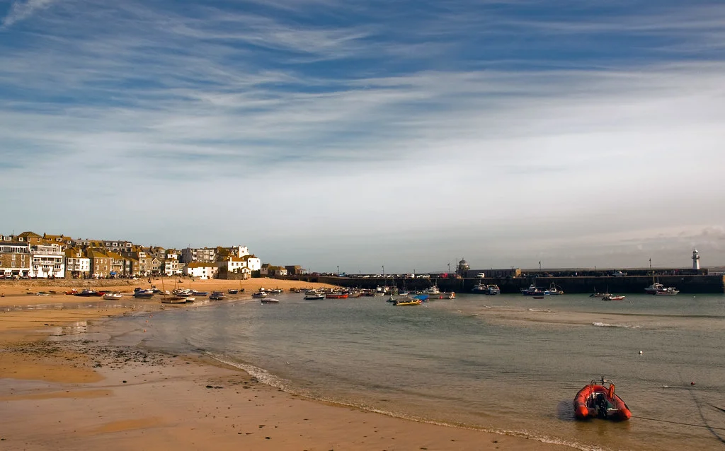 St Ives Harbour Beach with numerous boats at the harbour.Beaches in St Ives