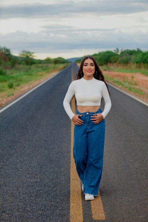 A Women wearing pair of denim pants with a wide leg cut, providing a relaxed and comfortable fit.