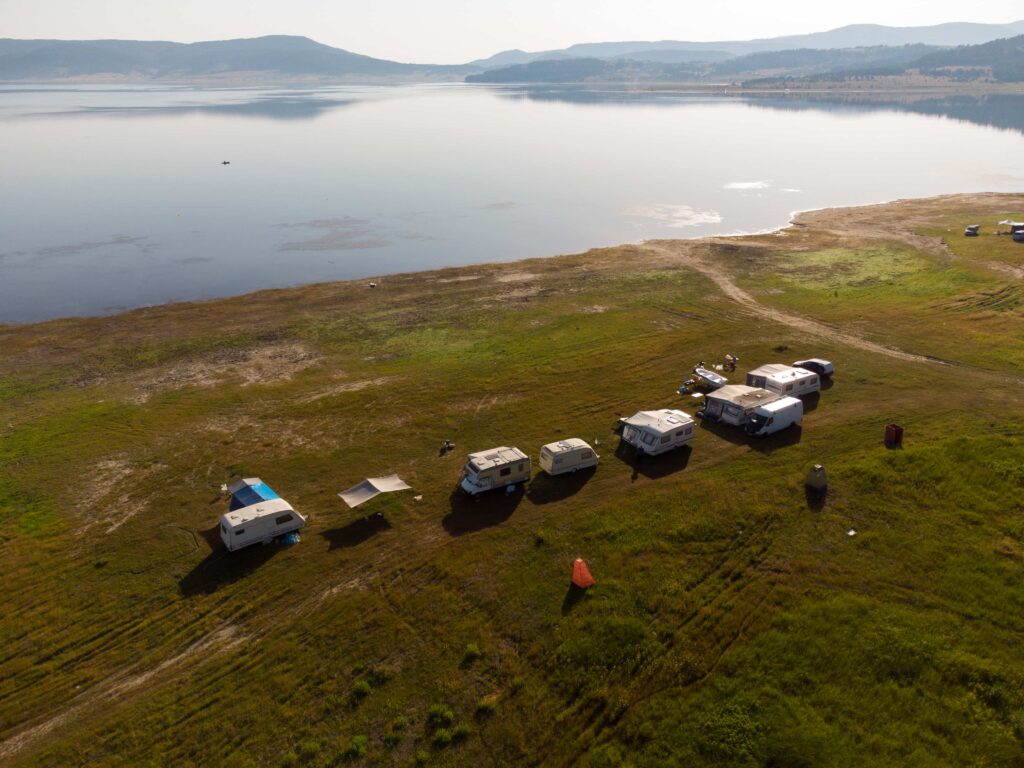 Peaceful lake at Cae Du Farm Holidays Campsite, showcasing the stunning scenery of Snowdonia National Park.