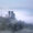 A foggy scene featuring Corfe Castle, with its ancient stone walls partially obscured, evoking a sense of mystery and history.