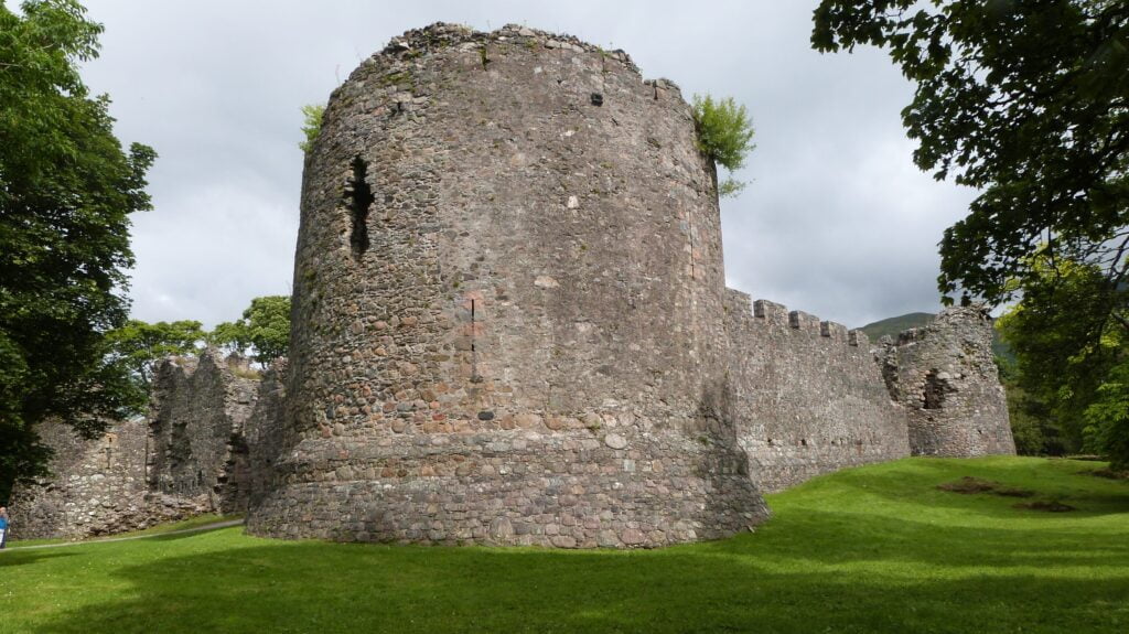 Old Inverlochy Castle stands proudly, its large stone walls telling tales of history and grandeur under the sun.