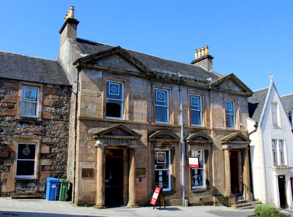The West Highland Museum, a grand structure adorned with numerous windows, inviting visitors to explore its rich history.