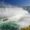 Captivating scene of Niagara Falls, Canada, featuring the iconic waterfalls and a boat from Niagara City Cruises in the foreground.