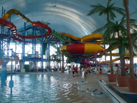 Exciting scene at Fallsview Indoor Waterpark showcasing a large slide and spacious pool, ideal for thrilling water adventures.